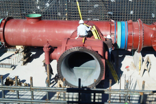 A Worker working on Giant Plumbing Pipe
